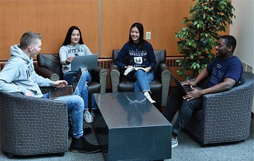 Four students studying together inside Williams Honor College Building.